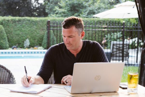 A MAN WORKS BESIDE A POOL