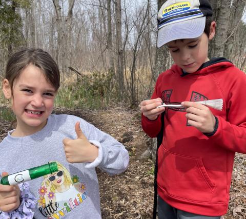Young explorers find a Raisin Region GeoAdventure cache at a local forest.